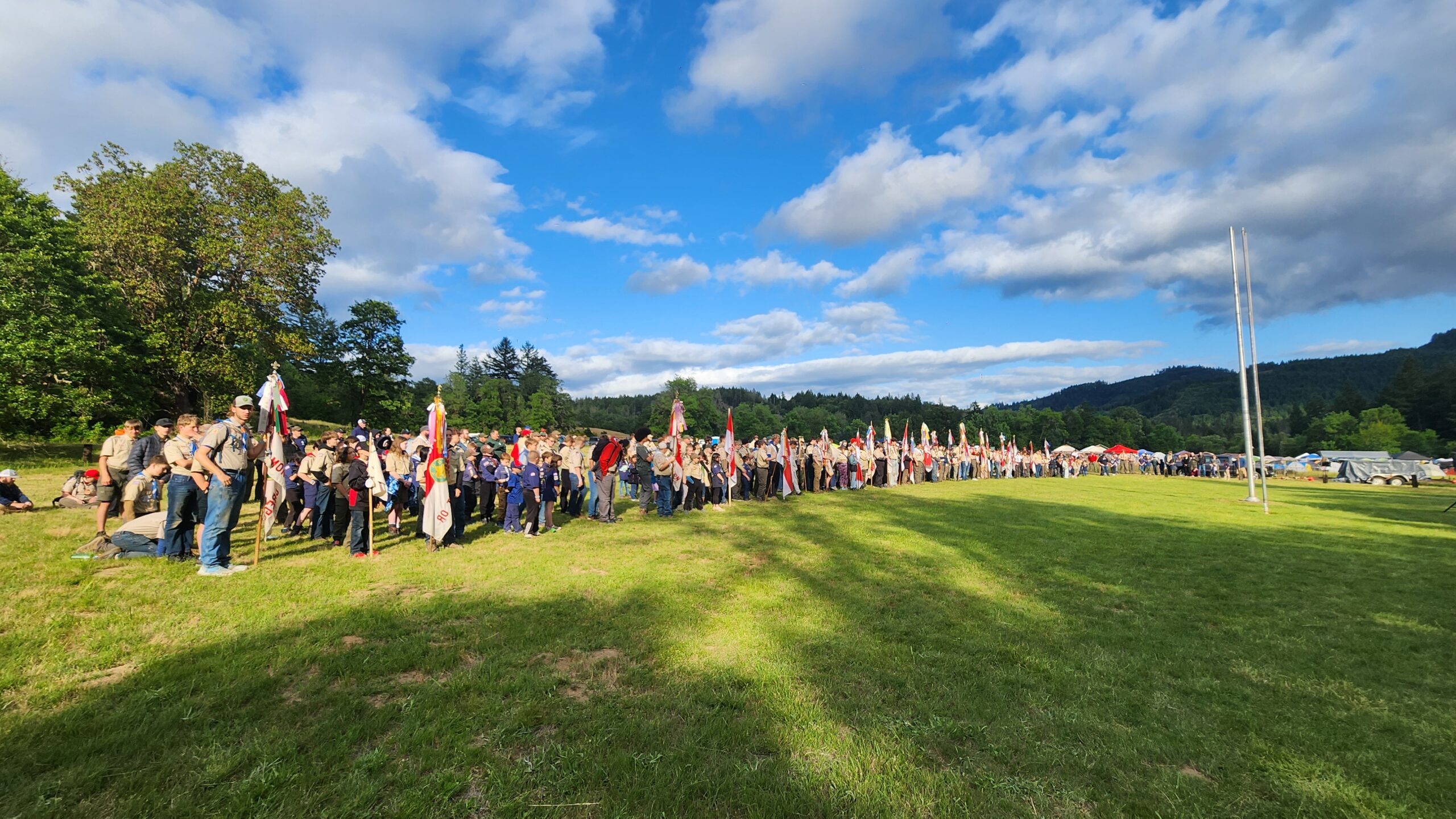 Scout units gather in lines for a flag ceremony